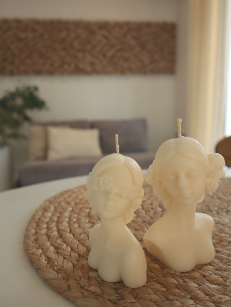 Qolachi Venus and Muse sculptural bust candles lit with flame
