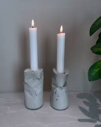 Lumière Sculptée handcrafted ceramic candle holders in sage grey matte glaze, set of two, with lit white taper candles