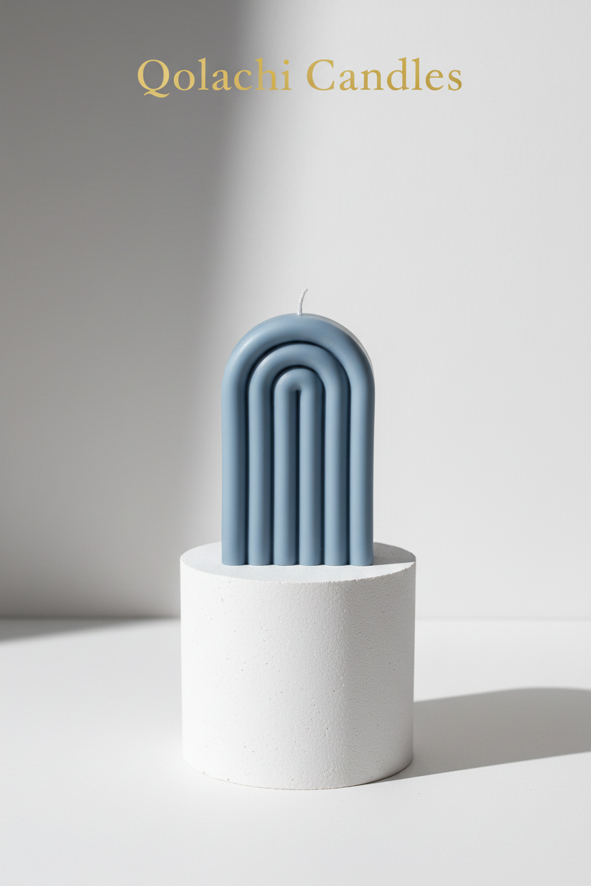 Arcadia Arch Candle — Dusty Slate on plaster pedestal