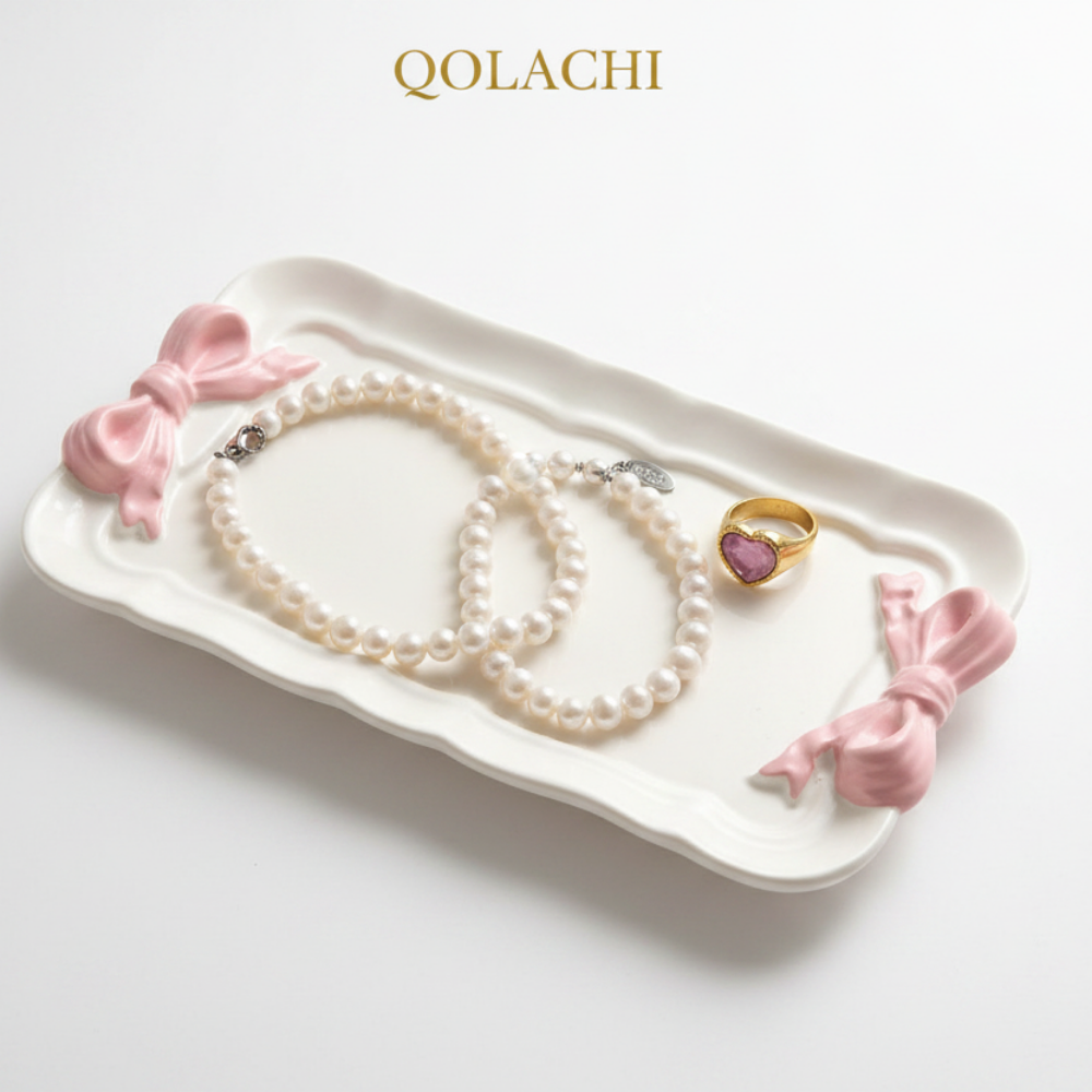 Qolachi white ceramic bow jewelry tray with pearl necklace and gold ring